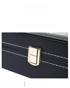 Detail of black PU leather watch box featuring white contrast stitching and silver metal lock