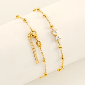 Elegant gold titanium steel bracelet with zircon bowknot charm and beaded chain