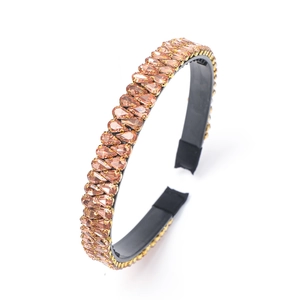 Baroque golden headband with amber glass rhinestones on a black base for women