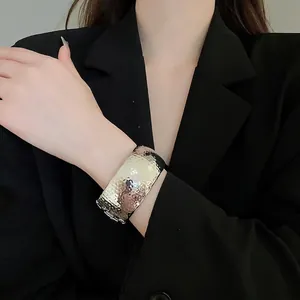 Wide hammered metal cuff bracelet with modern geometric design in silver finish