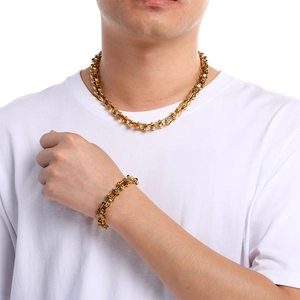 Men's gold-plated curved bamboo chain bracelet and necklace set shown on male model