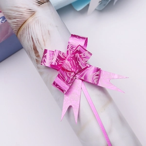 Macro detail of pink purple ribbon bow with rose patterns for gift packaging decoration