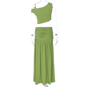 Detail of green one-shoulder crop top and slim fit maxi skirt with waist pleats