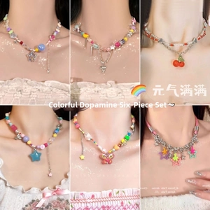 Model wearing a six-piece set of colorful dopamine necklaces with butterfly and star charms
