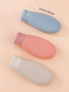 Three 60ml silicone travel bottles in blue pink and grey with 11cm size dimension
