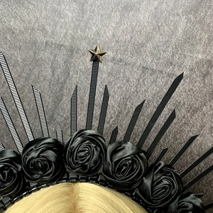 Macro view of gothic crown headband with black roses and radiating spikes