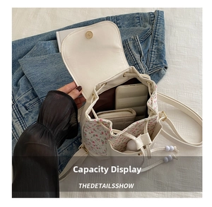 Detail showing internal capacity of the white floral backpack with smartphone and wallet