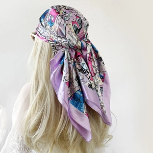 Artistic printed silk scarf worn as a headwrap in shades of purple and pink satin