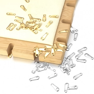 Macro shot of oval stainless steel connector tags for jewelry making in gold and silver