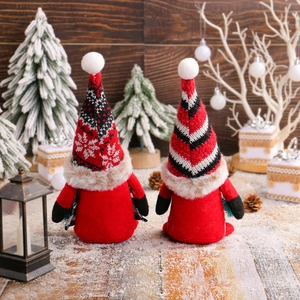 Charming red Christmas gnome set with striped hats in a cozy holiday indoor setting