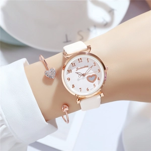 Elegant white leather watch with rose gold case and matching heart bracelet for women