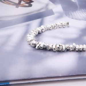 Macro shot of irregular 925 sterling silver beads for DIY handmade jewelry crafting