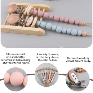 Silicone and beech wood baby pacifier clip chain in pink and blue color variants