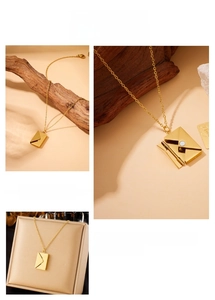 Detailed view of a gold envelope pendant on a stainless steel chain with a modern look