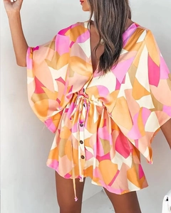 Detail of V-neckline and waist drawstring on a geometric print summer boho dress
