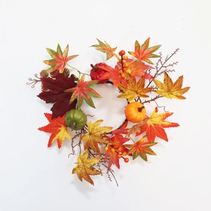 Autumn wreath with colorful maple leaves and mini pumpkins for Thanksgiving decoration