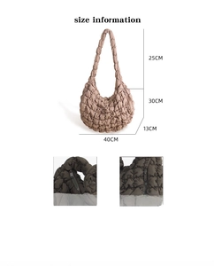 Detail view of large cloud shoulder bag featuring quilted texture and side zipper