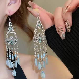 Bohemian silver earrings with blue crystal beads and ethnic floral hollow design