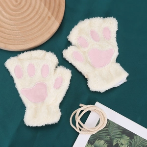 Detail view of plush fingerless cat paw gloves with pink pads on green background
