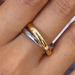 Minimalist two-tone crossover ring in gold and silver with sparkling cubic zirconia stones