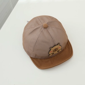 Close-up of baby mesh cap with cartoon bear patch and breathable brown fabric