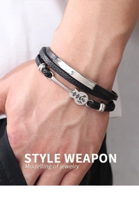 Detail showing a multilayer black leather guitar bracelet with a silver magnetic clasp