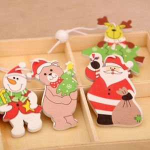 Detailed macro view of four wooden Christmas ornaments in a divided wooden tray