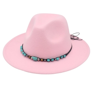 Detail of pink fedora with bohemian turquoise beaded band and woven trim decoration