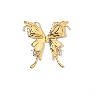 Detailed close-up of a gold butterfly pendant with hollow patterns and polished finish