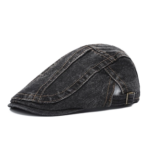 Detail of vintage washed denim newsboy cap showing metal buckle and stitching