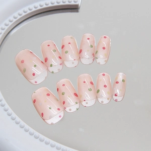 Chic pink cat-eye press-on nails with colorful polka dots and glossy oval finish
