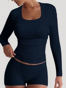 Navy blue ribbed yoga set featuring long sleeve U-neck top and matching shorts for women