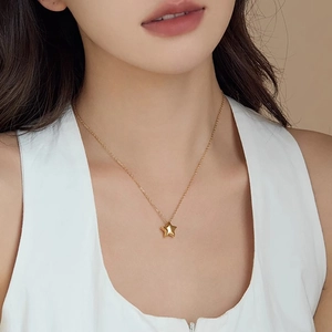 Collier avec pendentif étoile dorée élégante sur un mannequin pour un look raffiné
