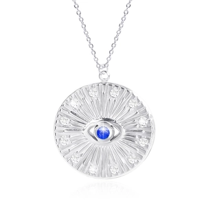 Macro shot of silver eye pendant featuring a blue center stone and tiny sparkling diamonds