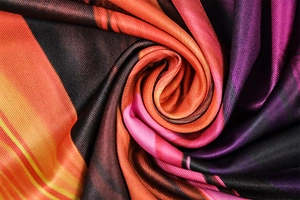Macro shot of striped satin fabric showing geometric prints and smooth silk texture