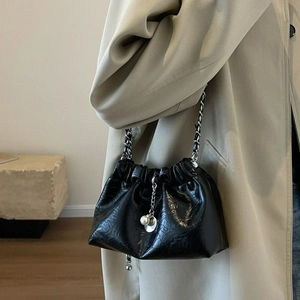 Black pleated cloud shoulder bag with silver chain strap and elegant pearl charm detail