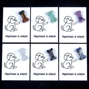 Set of six colorful natural crystal dog bone stones on healing cards for pet lovers