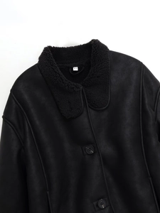 Close-up of black faux suede jacket featuring warm fleece collar and button details