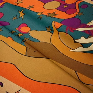 Close-up of bohemian tapestry fabric with stars, planets and abstract figure prints