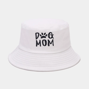 White canvas bucket hat featuring black Dog Mom embroidery and a paw print pattern