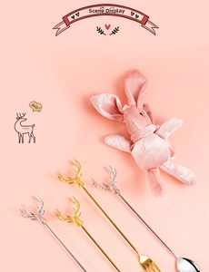 Detailed view of 304 stainless steel dessert spoons and forks with elk head handles