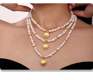Detail of a three-layer natural freshwater pearl necklace with 18k gold-plated pendants