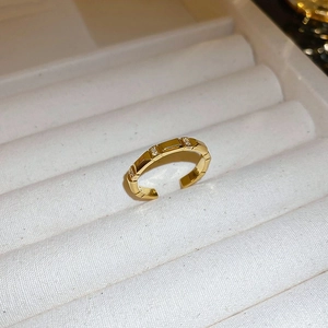 Detailed macro view of an adjustable gold-plated butterfly ring with sparkling cubic zirconia
