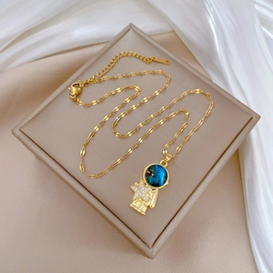 Elegant gold astronaut star pendant necklace with sparkling crystals and blue star dome