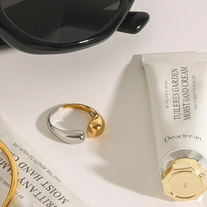 Two-tone stainless steel open ring with polished gold and silver spherical ends