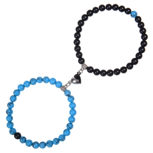 Close-up of matte black and blue zebra stone bracelets with heart magnetic clasps