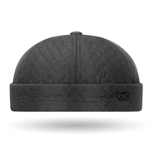 Men's black quilted docker hat with rhombus patterns and metal sports label