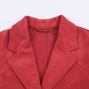 Detail view of the red faux suede texture and lapel collar on the fashion jacket