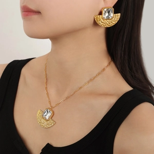 Elegant gold fan-shaped necklace and earrings set with transparent rectangle crystals