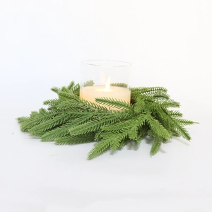 Detail view of Norfolk pine candle ring with green artificial needles and glass cup holder